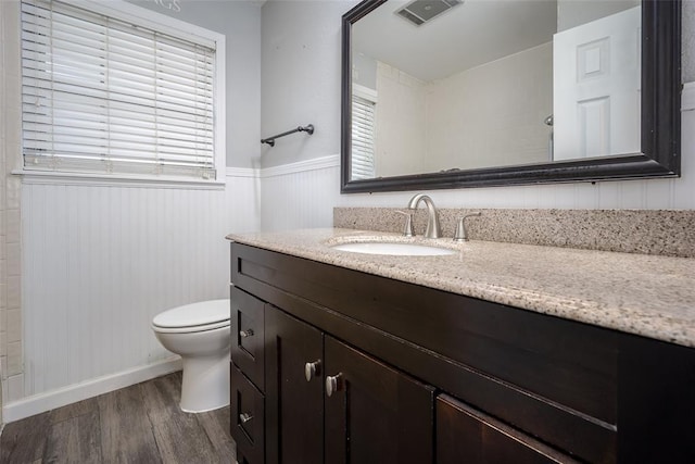 1527 N Pennsylvania Ave, Shawnee, OK 74804 - bathroom featuring vanity, wood finished floors, and wainscoting