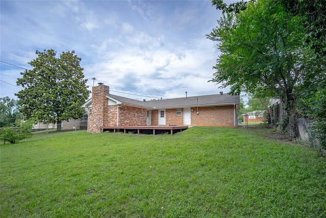 1527 N Pennsylvania Ave, Shawnee, OK 74804 - back of property featuring a fenced backyard, a chimney, brick siding, and a wooden deck