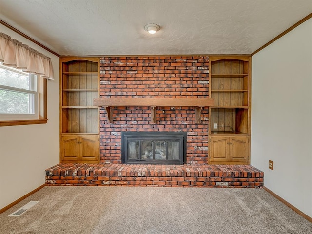 unfurnished living room featuring built in features, visible vents, carpet, and a textured ceiling