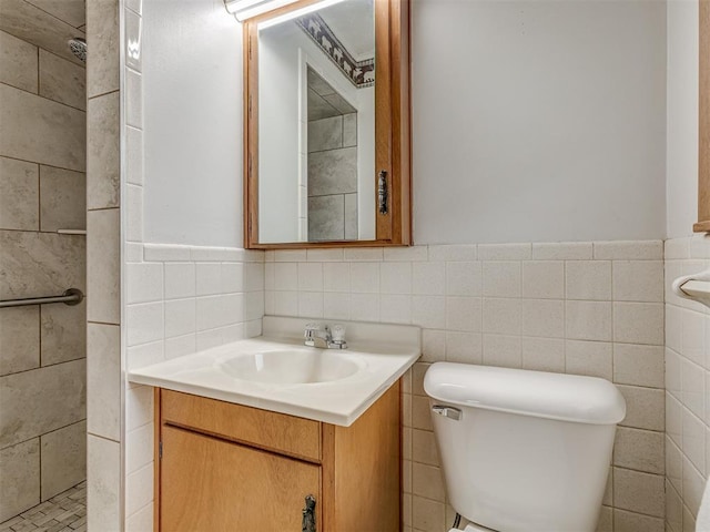 bathroom with a wainscoted wall, tile walls, toilet, and vanity