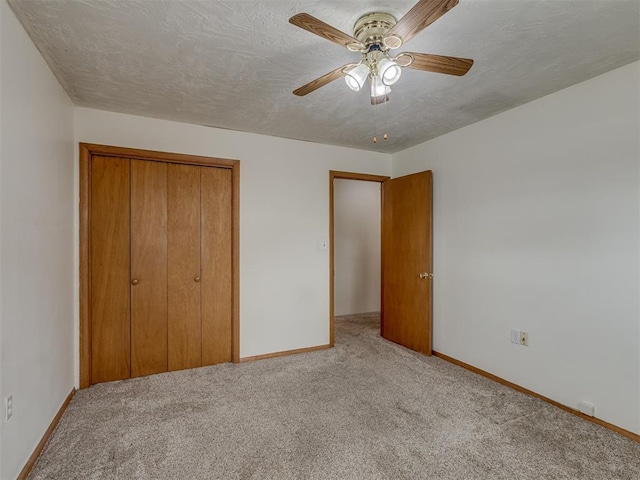 unfurnished bedroom featuring a closet, carpet floors, and baseboards