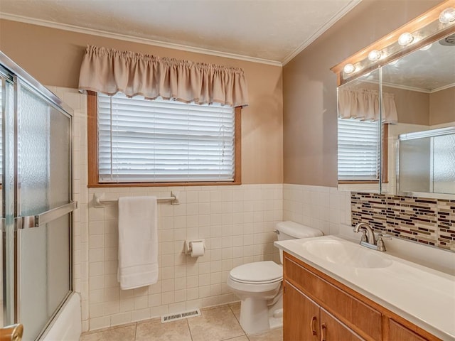 bathroom featuring tile patterned flooring, vanity, toilet, ornamental molding, and visible vents