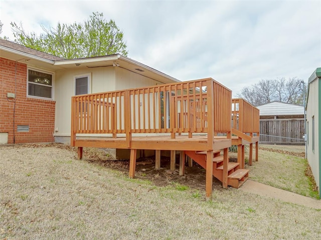 wooden deck with a lawn and fence