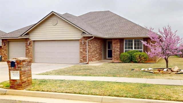 ranch-style home featuring a garage, concrete driveway, brick siding, a front lawn, and roof with shingles