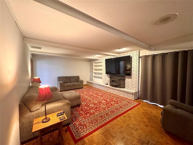 living area featuring beamed ceiling, visible vents, and a textured ceiling