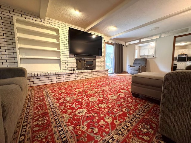 living area with beam ceiling and a textured ceiling