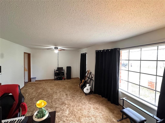 living room featuring ceiling fan, carpet floors, and a textured ceiling