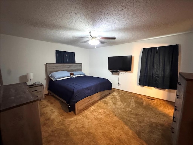 bedroom with carpet floors, ceiling fan, and a textured ceiling