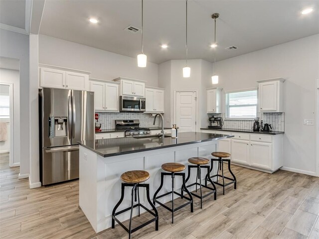 8512 NW 77th St, Oklahoma City, OK 73132 - kitchen with stainless steel appliances, visible vents, and dark countertops