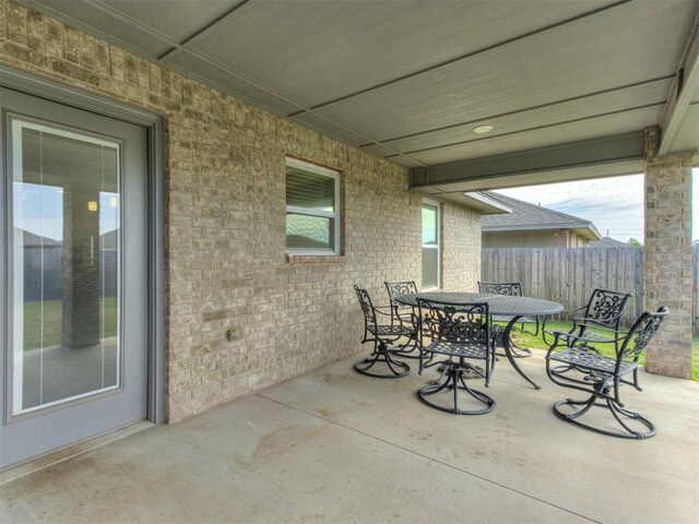 8512 NW 77th St, Oklahoma City, OK 73132 - view of patio / terrace featuring outdoor dining area and fence