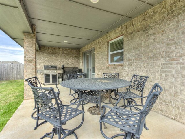 8512 NW 77th St, Oklahoma City, OK 73132 - view of patio / terrace with fence and outdoor dining area