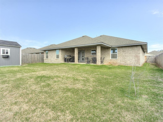 8512 NW 77th St, Oklahoma City, OK 73132 - back of property featuring a yard, a fenced backyard, a patio, brick siding, and roof with shingles
