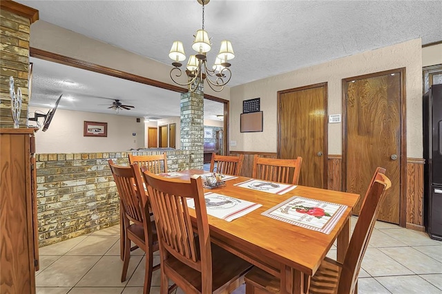 13989 US Highway 183, Hobart, OK 73651 - dining room with a textured ceiling, ornate columns, light tile patterned floors, a chandelier, and a ceiling fan