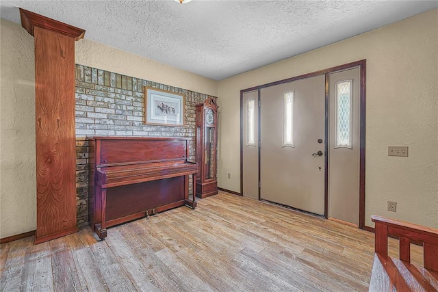 13989 US Highway 183, Hobart, OK 73651 - entryway featuring a textured ceiling, a textured wall, light wood-type flooring, and baseboards