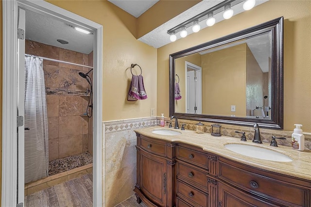 13989 US Highway 183, Hobart, OK 73651 - bathroom with tile walls, double vanity, tiled shower, and a wainscoted wall