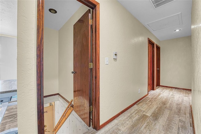 13989 US Highway 183, Hobart, OK 73651 - hall featuring light wood-type flooring, an upstairs landing, a textured wall, and baseboards