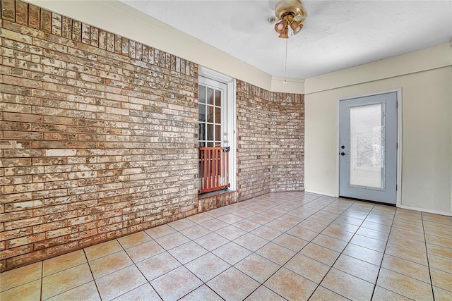 13989 US Highway 183, Hobart, OK 73651 - spare room featuring brick wall and light tile patterned floors