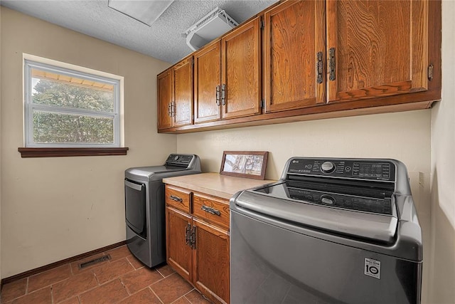 13989 US Highway 183, Hobart, OK 73651 - laundry room with cabinet space, baseboards, washer and dryer, and a textured ceiling