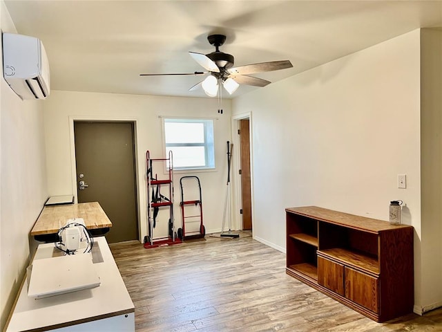 13989 US Highway 183, Hobart, OK 73651 - office area featuring a wall mounted air conditioner, ceiling fan, light wood-style floors, and baseboards