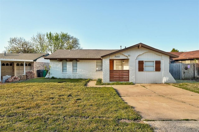 7440 NW 5th Ter, Oklahoma City, OK 73127 - view of front of house with a front yard, fence, and brick siding