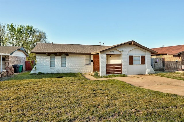 7440 NW 5th Ter, Oklahoma City, OK 73127 - single story home with fence, a front lawn, and brick siding