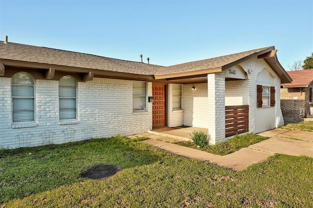 7440 NW 5th Ter, Oklahoma City, OK 73127 - single story home with a shingled roof, a front lawn, and brick siding