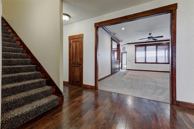 foyer entrance with baseboards, stairs, crown molding, and hardwood / wood-style flooring