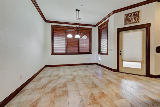 spare room featuring baseboards, ornamental molding, and a notable chandelier