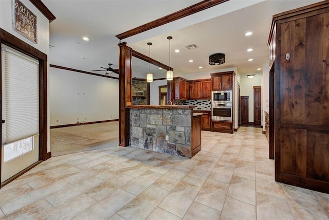 kitchen featuring a peninsula, crown molding, stainless steel appliances, a ceiling fan, and backsplash