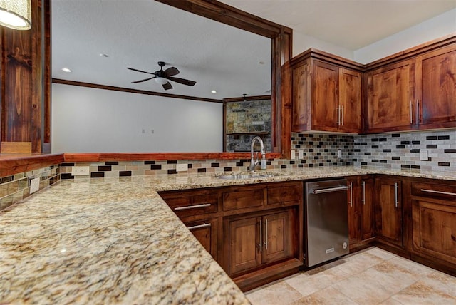 kitchen with a ceiling fan, a sink, ornamental molding, and light stone countertops