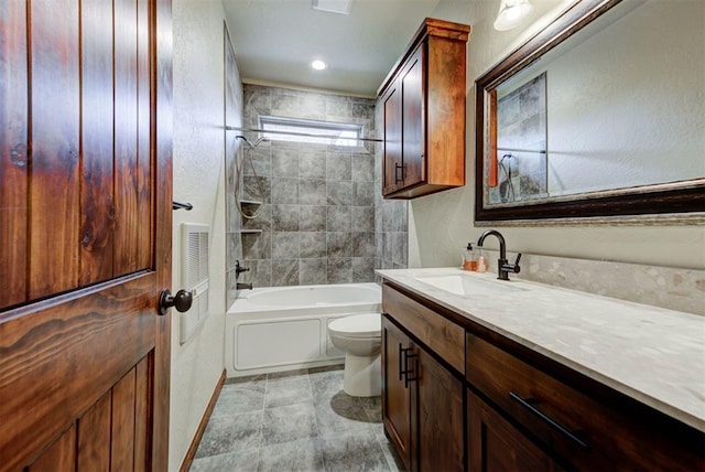 bathroom with tub / shower combination, vanity, and toilet