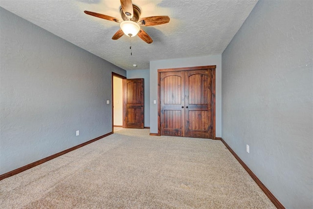 unfurnished bedroom featuring a textured wall and a textured ceiling