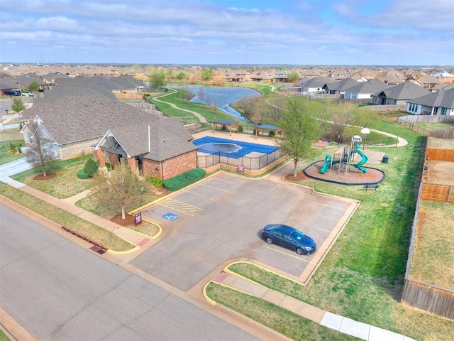 birds eye view of property featuring a water view and a residential view