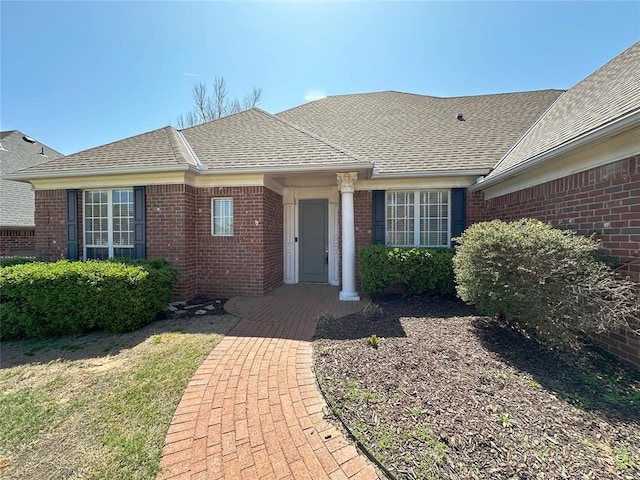 4000 Harrogate Dr, Norman, OK 73072 - doorway to property featuring brick siding and roof with shingles