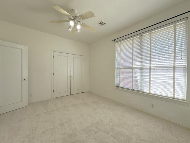 4000 Harrogate Dr, Norman, OK 73072 - unfurnished bedroom featuring carpet flooring, a closet, ceiling fan, and visible vents