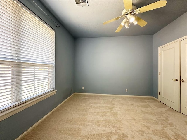 4000 Harrogate Dr, Norman, OK 73072 - spare room featuring baseboards, visible vents, a ceiling fan, and light carpet