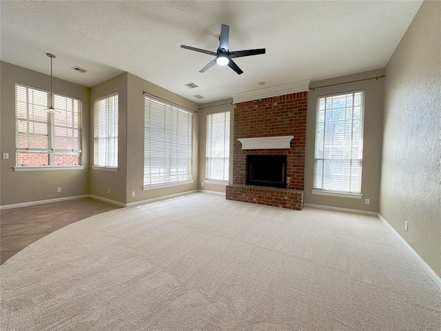 4000 Harrogate Dr, Norman, OK 73072 - unfurnished living room featuring a textured wall, a textured ceiling, carpet floors, ceiling fan, and visible vents