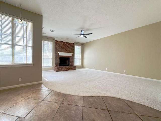 4000 Harrogate Dr, Norman, OK 73072 - unfurnished living room with carpet flooring, a textured ceiling, visible vents, a ceiling fan, and a fireplace