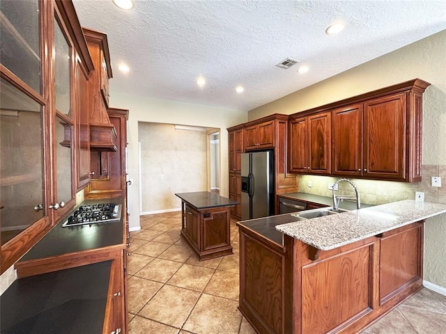 4000 Harrogate Dr, Norman, OK 73072 - kitchen with decorative backsplash, visible vents, stainless steel appliances, a sink, and a center island