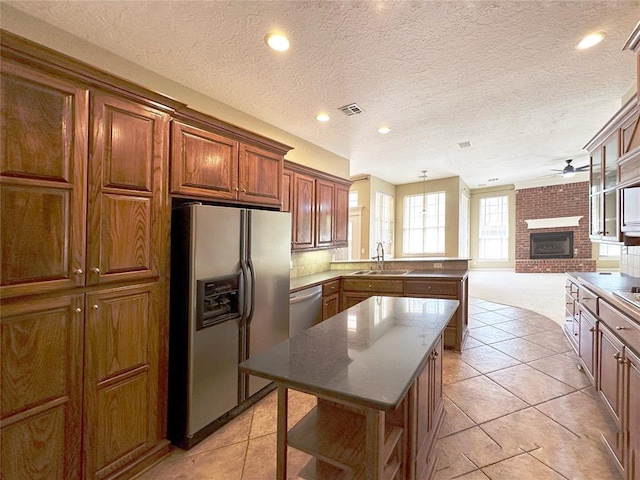 4000 Harrogate Dr, Norman, OK 73072 - kitchen with a sink, appliances with stainless steel finishes, a peninsula, visible vents, and ceiling fan