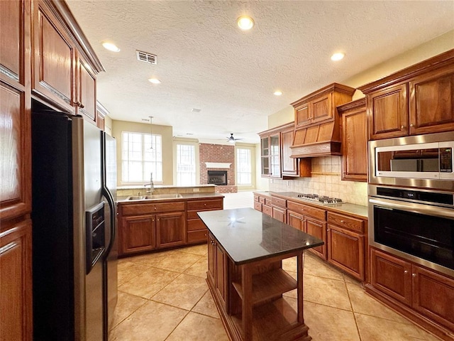 4000 Harrogate Dr, Norman, OK 73072 - kitchen featuring visible vents, appliances with stainless steel finishes, a sink, open shelves, and backsplash