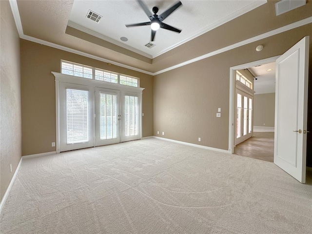4000 Harrogate Dr, Norman, OK 73072 - carpeted spare room with a tray ceiling, visible vents, ceiling fan, and french doors