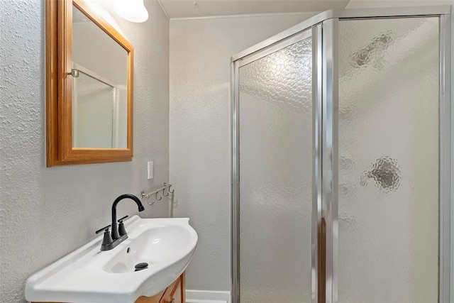923 NE 19th St, Oklahoma City, OK 73105 - full bathroom with a stall shower, vanity, and a textured wall