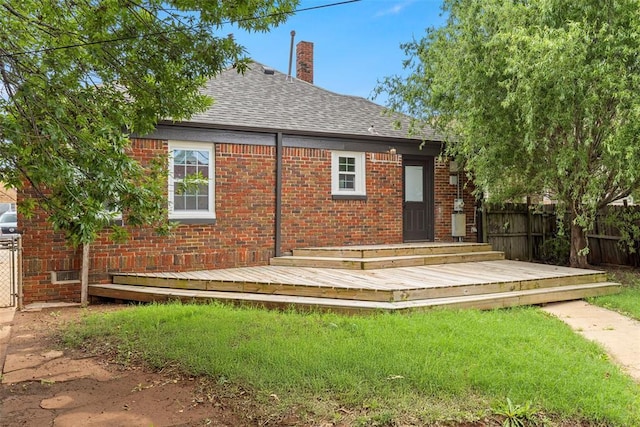 923 NE 19th St, Oklahoma City, OK 73105 - rear view of house featuring a shingled roof, a wooden deck, and brick siding