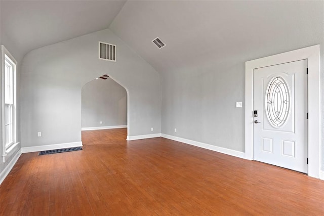 923 NE 19th St, Oklahoma City, OK 73105 - foyer entrance featuring vaulted ceiling, wood finished floors, baseboards, and arched walkways