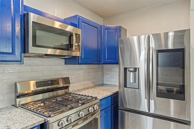 923 NE 19th St, Oklahoma City, OK 73105 - kitchen with stainless steel appliances, blue cabinets, tasteful backsplash, ornamental molding, and light stone countertops