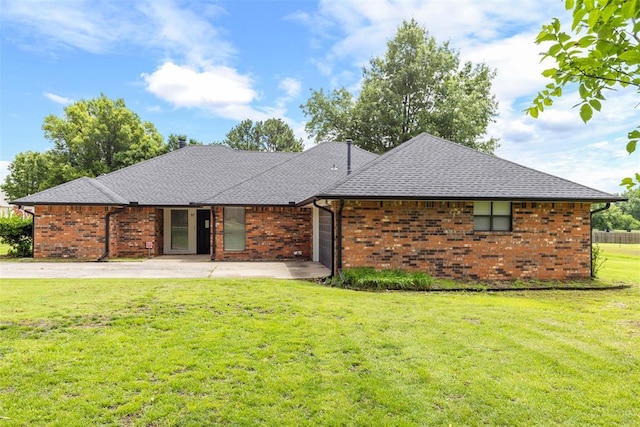 57 Serenada Ln, Shawnee, OK 74804 - view of front of property with a front lawn, brick siding, and a shingled roof