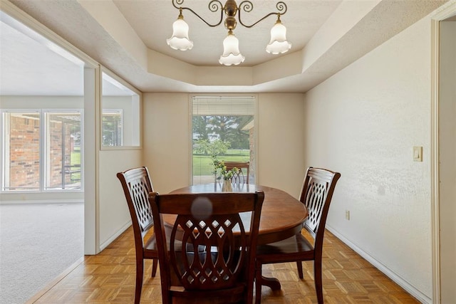 57 Serenada Ln, Shawnee, OK 74804 - dining space featuring baseboards, a tray ceiling, and a chandelier