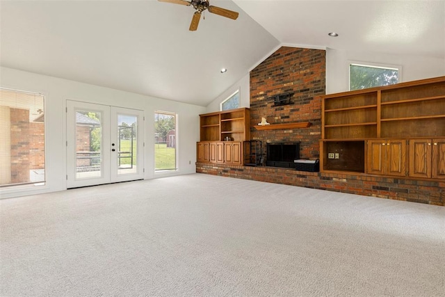 57 Serenada Ln, Shawnee, OK 74804 - unfurnished living room with carpet floors, a ceiling fan, plenty of natural light, a brick fireplace, and high vaulted ceiling