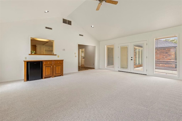 57 Serenada Ln, Shawnee, OK 74804 - unfurnished living room with light carpet, french doors, a ceiling fan, baseboards, and high vaulted ceiling